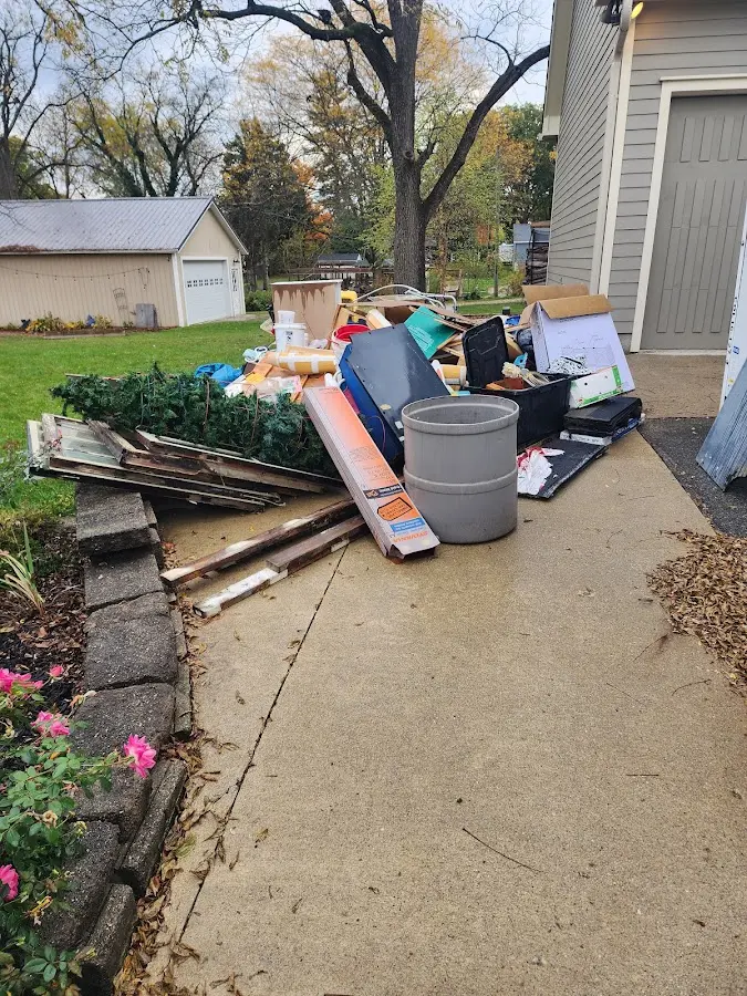 Dumpster being loaded with debris for Roofing Dumpster Rental in Fountainhead-Orchard Hills